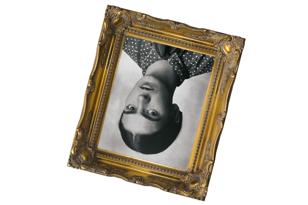 A black-and-white portrait in an ornate gold frame, hung upside down